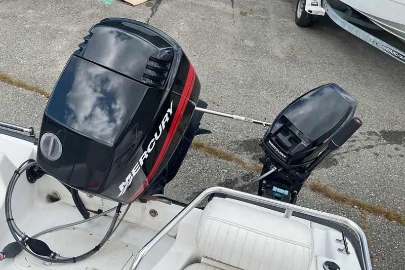 Slide: The Image of Boston Whaler Dauntless 16 (2000) with Mercury outboard motors on a trailer. - 10