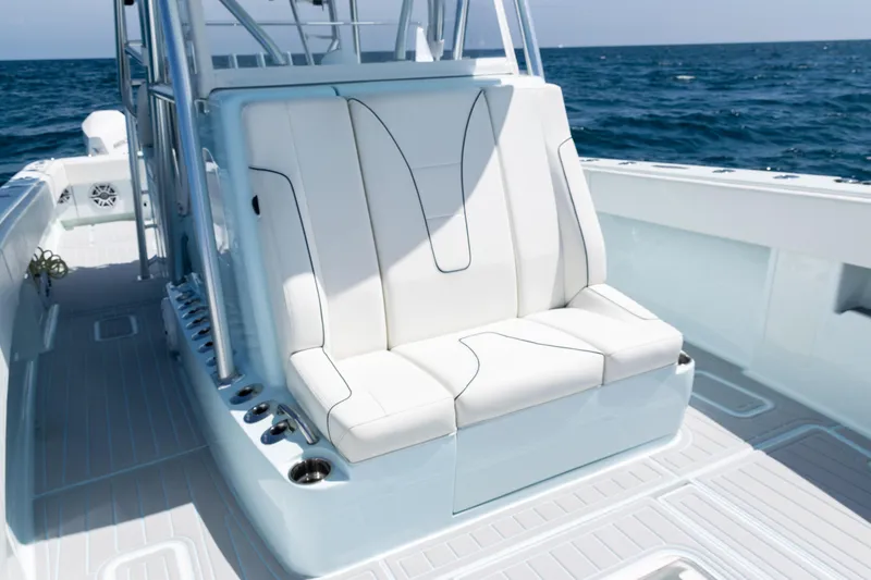 Slide: The Image of 2023 SeaVee 390Z boat with sleek white seating and ocean backdrop. - 11