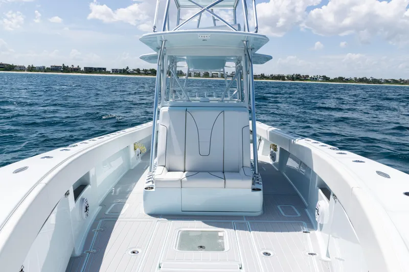 Slide: The Image of 2023 SeaVee 390Z boat with white seating, ocean backdrop, and sleek design. - 12