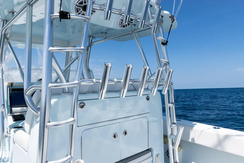 Slide: The Image of 2023 SeaVee 390Z boat with rod holders and ladder, ocean backdrop. - 15