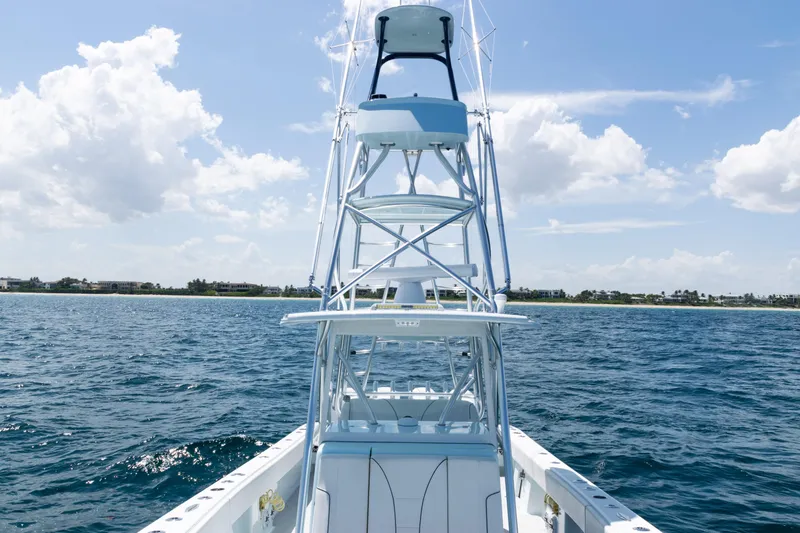 Slide: The Image of 2023 SeaVee 390Z boat on open ocean, clear sky, and distant shoreline. - 25