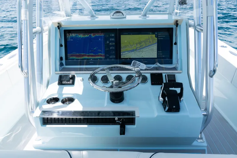 Slide: The Image of 2023 SeaVee 390Z boat dashboard with navigation screens and controls, overlooking the ocean. - 27