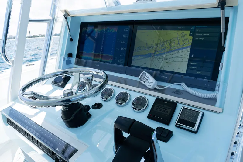 Slide: The Image of 2023 SeaVee 390Z boat console with advanced navigation and control systems on open water. - 28