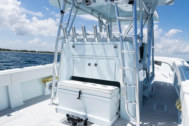 Slide: The Image of 2023 SeaVee 390Z boat with rod holders, ocean view, and clear blue sky. - 32