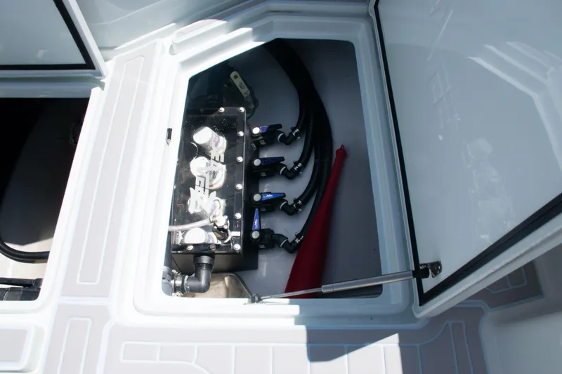 Slide: The Image of 2023 SeaVee 390Z boat compartment with visible wiring and plumbing components. - 39