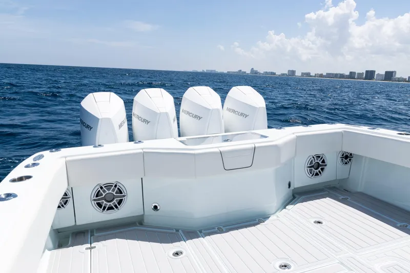 Slide: The Image of 2023 SeaVee 390Z boat deck with storage and rod holders, under a clear sky. - 41