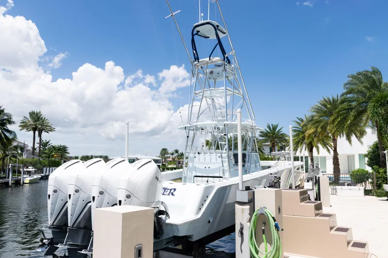 Slide: The Image of 2023 SeaVee 390Z boat docked by tropical waterfront under blue sky. - 53