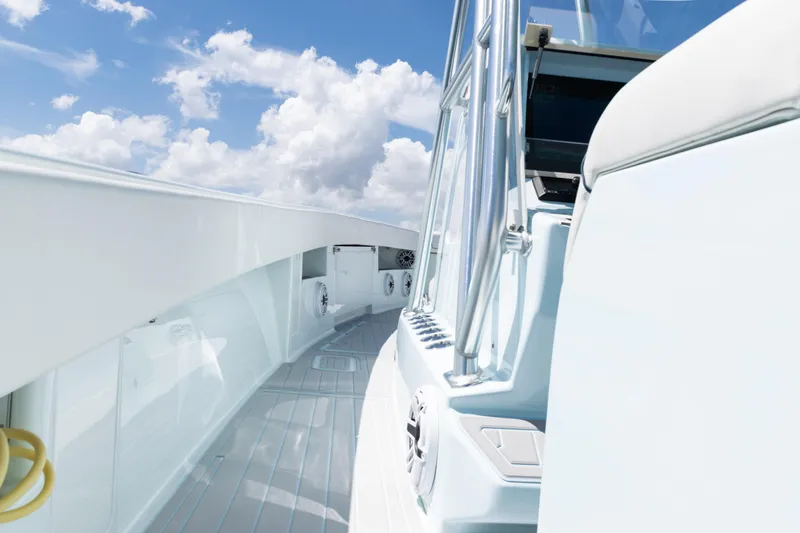 Slide: The Image of 2023 SeaVee 390Z boat tower with rod holders and speakers against a blue sky. - 57