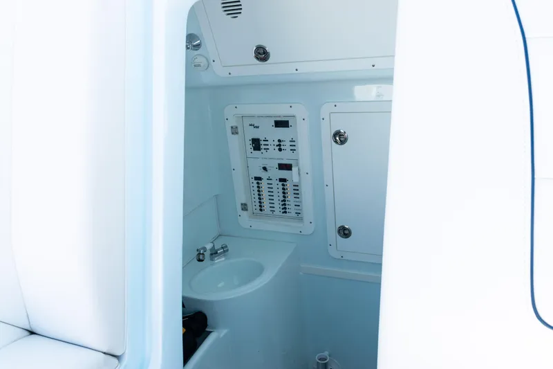 Slide: The Image of 2023 SeaVee 390Z boat on open water with coastal skyline in background. - 59