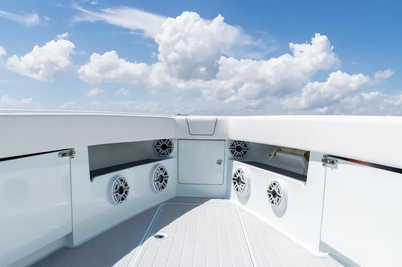 Slide: The Image of 2023 SeaVee 390Z boat deck with speakers under a bright blue sky. - 7