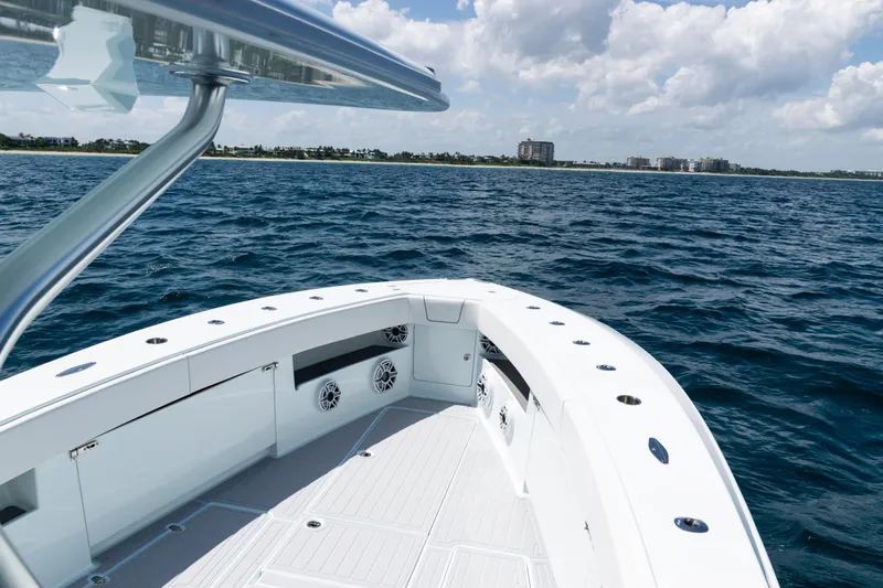 Slide: The Image of 2023 SeaVee 390Z boat deck with speakers under a bright blue sky. - 8
