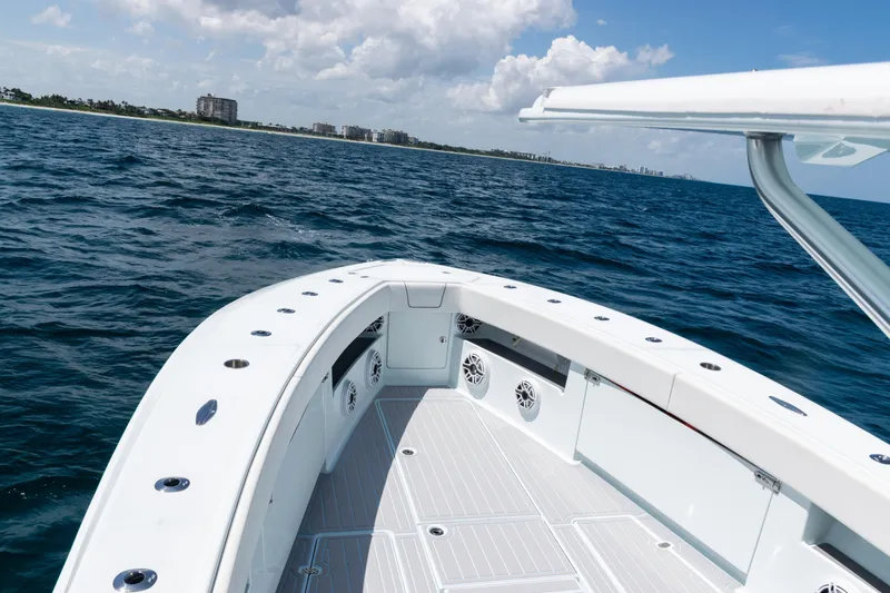 Slide: The Image of 2023 SeaVee 390Z boat on open water, showcasing sleek design and spacious deck. - 9