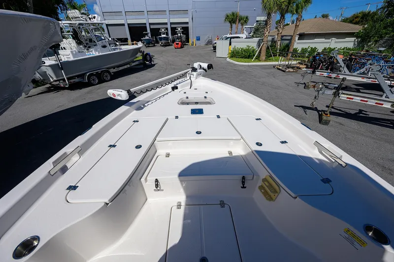 Slide: The Image of 2021 Blue Wave 2600 PureBay boat deck with storage compartments and trolling motor. - 11