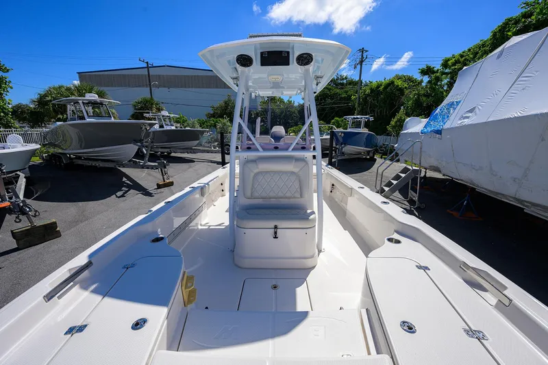Slide: The Image of 2021 Blue Wave 2600 PureBay boat in a sunny outdoor showroom. - 14