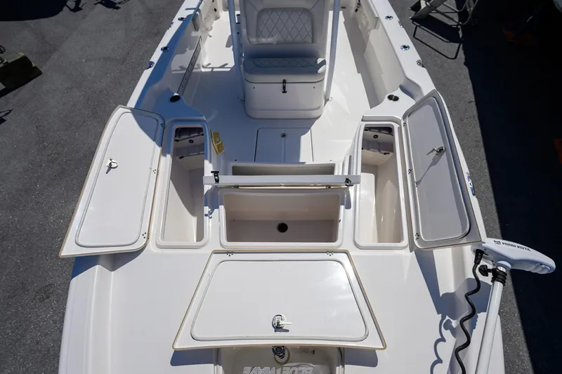 Slide: The Image of 2021 Blue Wave 2600 PureBay boat with open storage compartments and seating. - 19