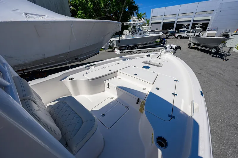 Slide: The Image of 2021 Blue Wave 2600 PureBay boat interior with seating and storage compartments. - 21
