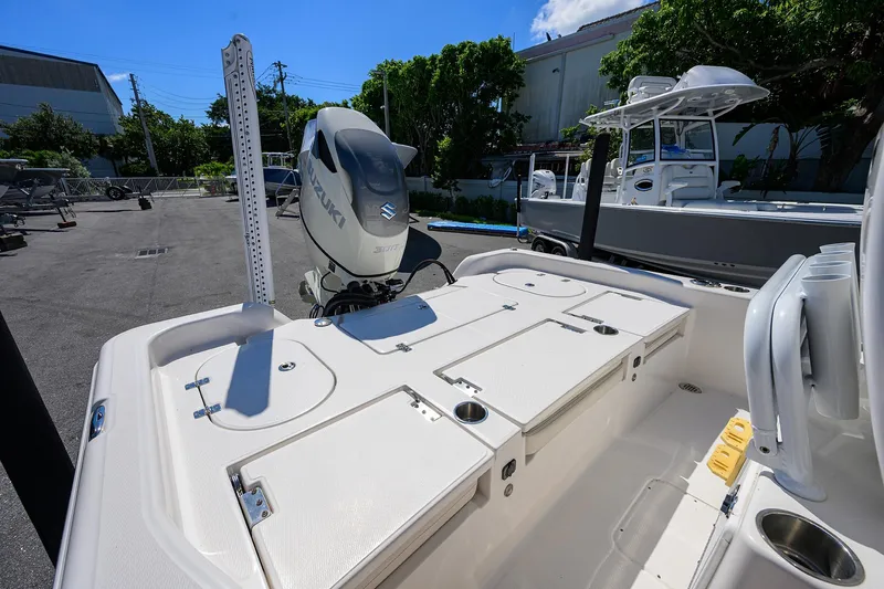 Slide: The Image of 2021 Blue Wave 2600 PureBay boat with Suzuki engine, docked outdoors. - 26