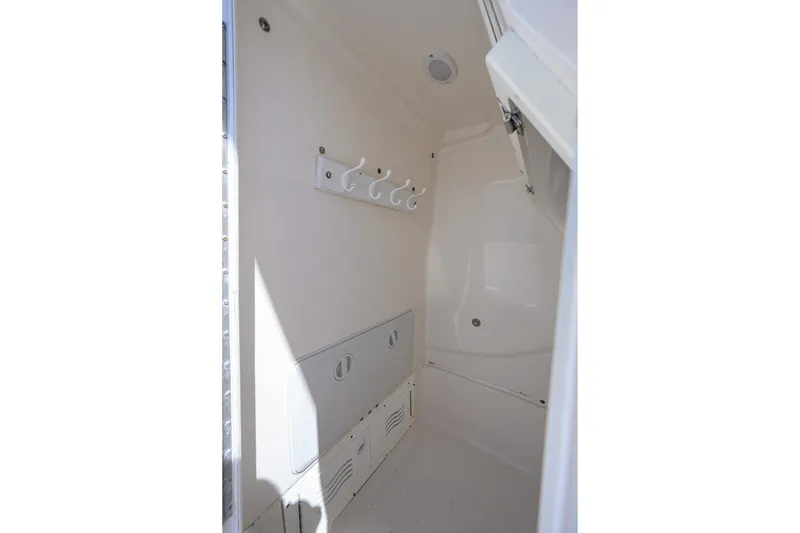 Slide: The Image of Interior storage compartment of 2021 Blue Wave 2600 PureBay boat, featuring hooks and ventilation. - 37
