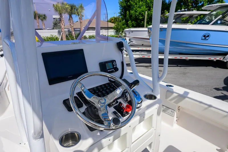 Slide: The Image of 2021 Blue Wave 2600 PureBay boat console with steering wheel and navigation equipment. - 43