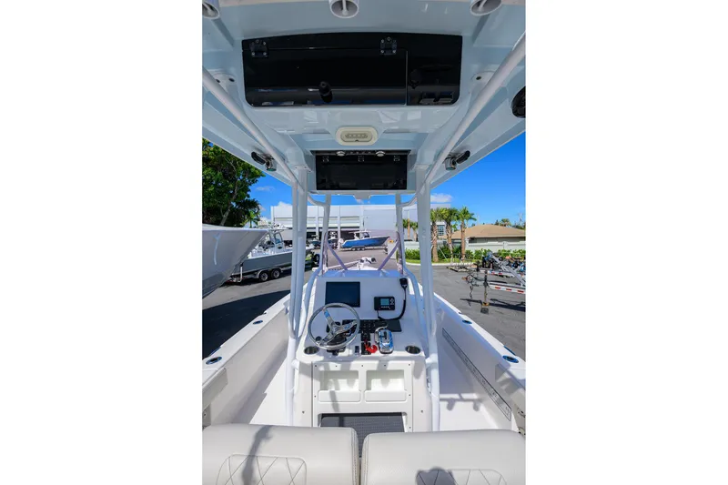 Slide: The Image of 2021 Blue Wave 2600 PureBay boat interior with steering console and navigation equipment. - 45