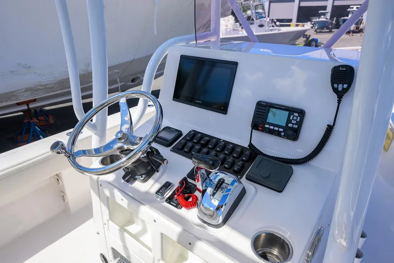 Slide: The Image of Control panel of 2021 Blue Wave 2600 PureBay boat with steering wheel and electronics. - 46
