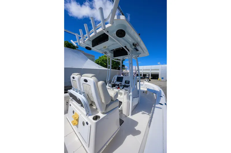 Slide: The Image of 2021 Blue Wave 2600 PureBay boat interior with dual seats and navigation equipment. - 48