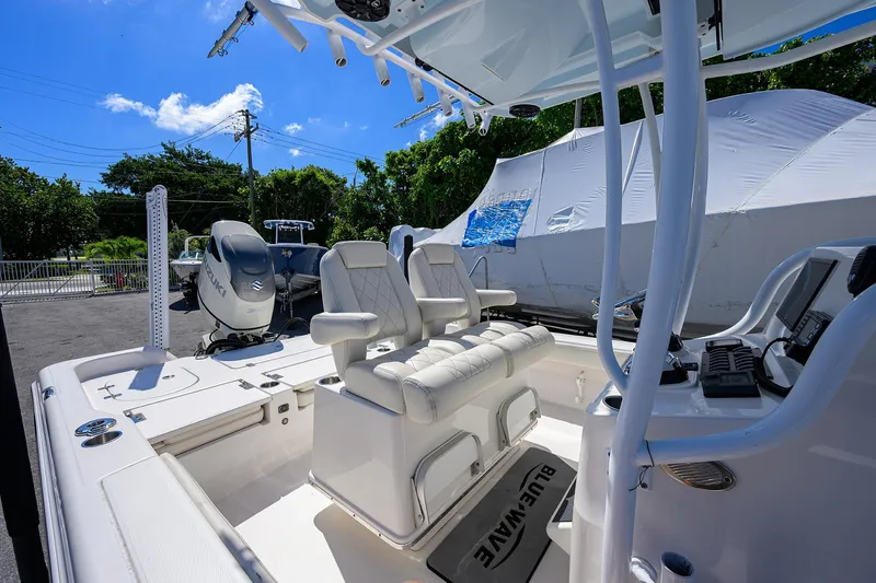 Slide: The Image of 2021 Blue Wave 2600 PureBay boat interior with seating and controls. - 50