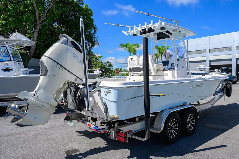 Slide: The Image of 2021 Blue Wave 2600 PureBay boat on trailer with Suzuki outboard motor. - 7
