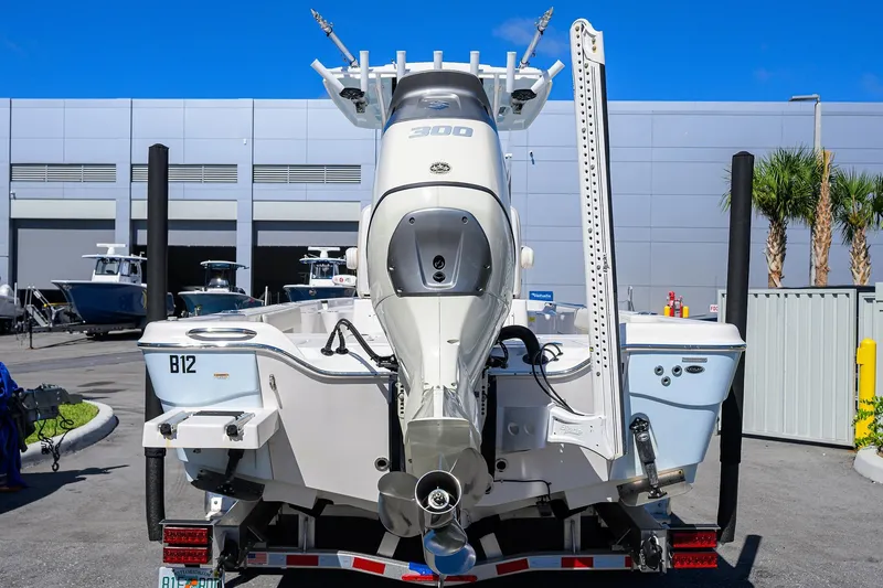 Slide: The Image of 2021 Blue Wave 2600 PureBay boat with powerful outboard motor, parked at a marina. - 8