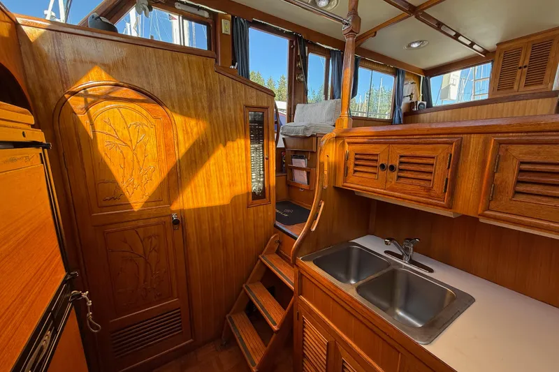 Slide: The Image of Interior of 1983 CHB 41 Classic Trawler with wooden cabinetry and dual sink. - 13