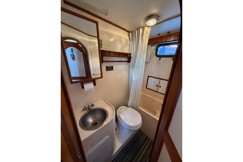 Slide: The Image of 1983 CHB 41 Classic Trawler bathroom with sink, toilet, and shower. - 20