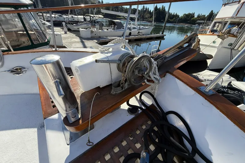 Slide: The Image of 1983 CHB 41 Classic Trawler deck with winch and ropes at marina. - 32