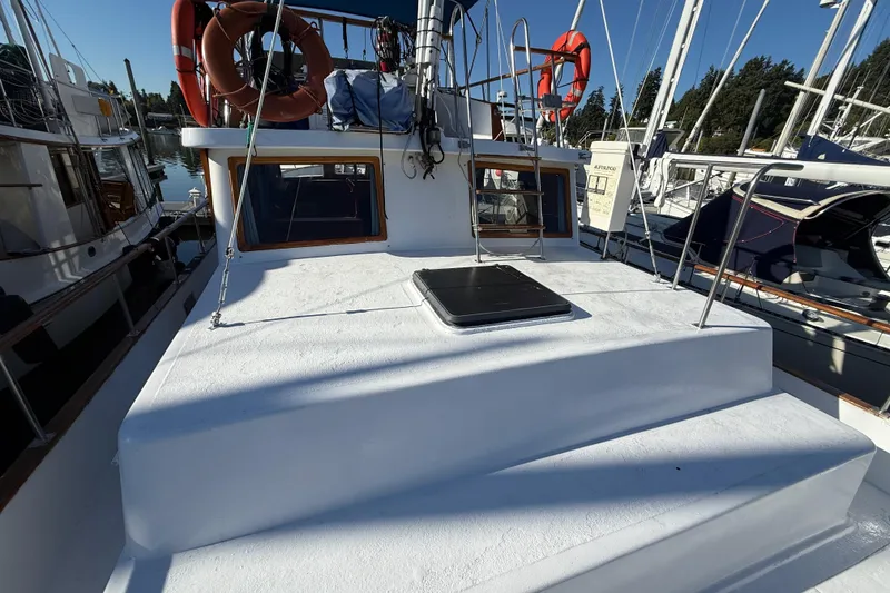 Slide: The Image of 1983 CHB 41 Classic Trawler boat deck with lifebuoys and marina view. - 37