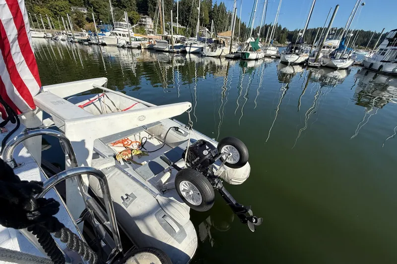 Slide: The Image of 1983 CHB 41 Classic Trawler docked with dinghy and American flag in marina. - 38