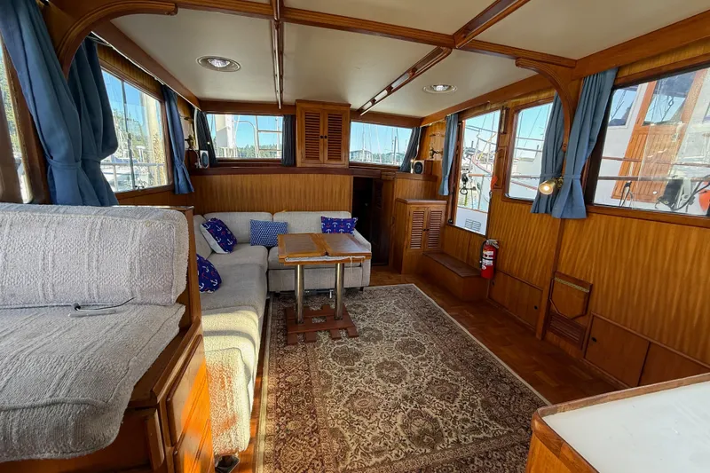 Slide: The Image of Interior of 1983 CHB 41 Classic Trawler with cozy seating, wooden accents, and nautical decor. - 4