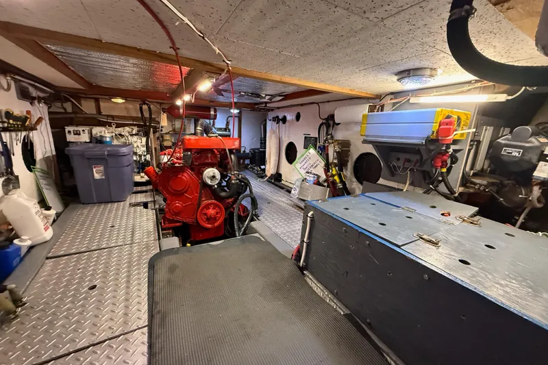 Slide: The Image of Engine room of 1983 CHB 41 Classic Trawler with red engine and organized equipment. - 40