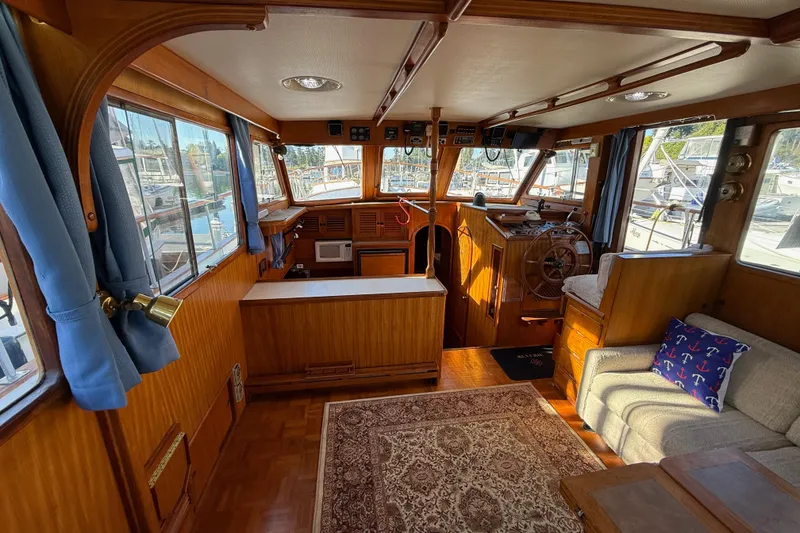 Slide: The Image of Interior of 1983 CHB 41 Classic Trawler with wood paneling and nautical decor. - 5
