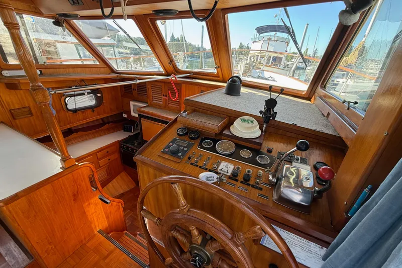 Slide: The Image of 1983 CHB 41 Classic Trawler helm with wooden interior and navigation controls. - 6