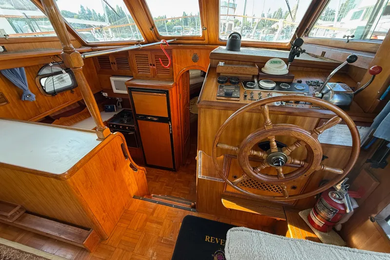Slide: The Image of Interior of 1983 CHB 41 Classic Trawler with wooden helm and navigation controls. - 7