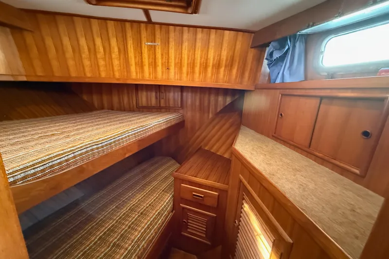 Slide: The Image of 1983 CHB 41 Classic Trawler cabin with wooden interior and bunk beds. - 8