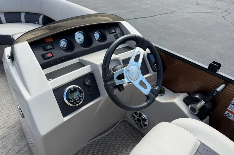 Slide: The Image of 2019 Bennington 22SX Premier boat dashboard with steering wheel and gauges. - 13