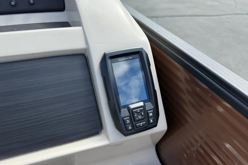 Slide: The Image of Garmin device on 2019 Bennington 22SX Premier boat dashboard, reflecting sky. - 15