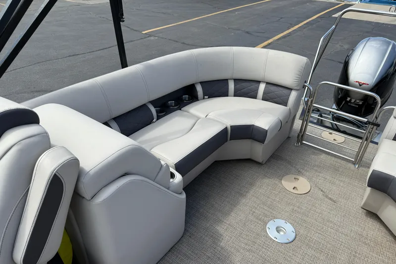Slide: The Image of 2019 Bennington 22SX Premier boat interior with plush seating and Yamaha 115 engine. - 18