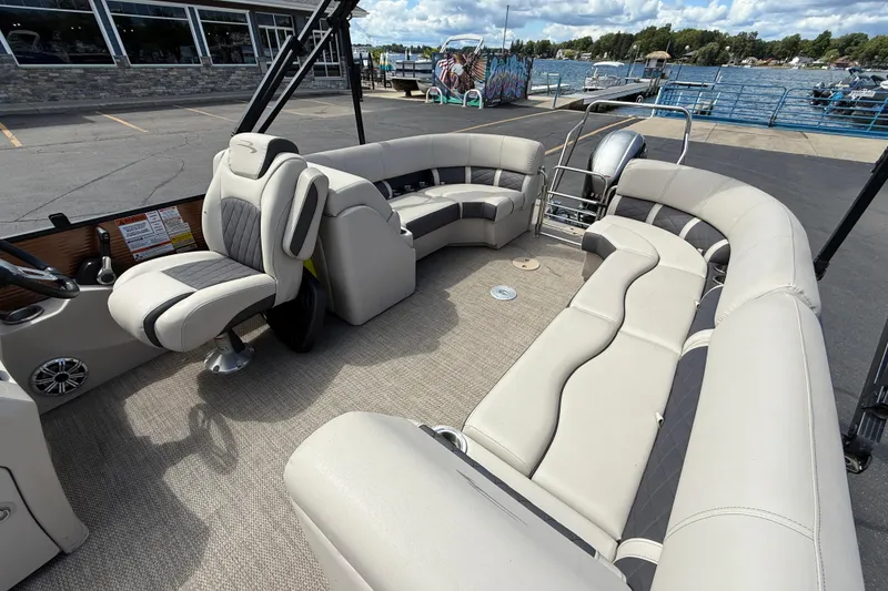 Slide: The Image of 2019 Bennington 22SX Premier pontoon boat with spacious seating and modern design. - 22