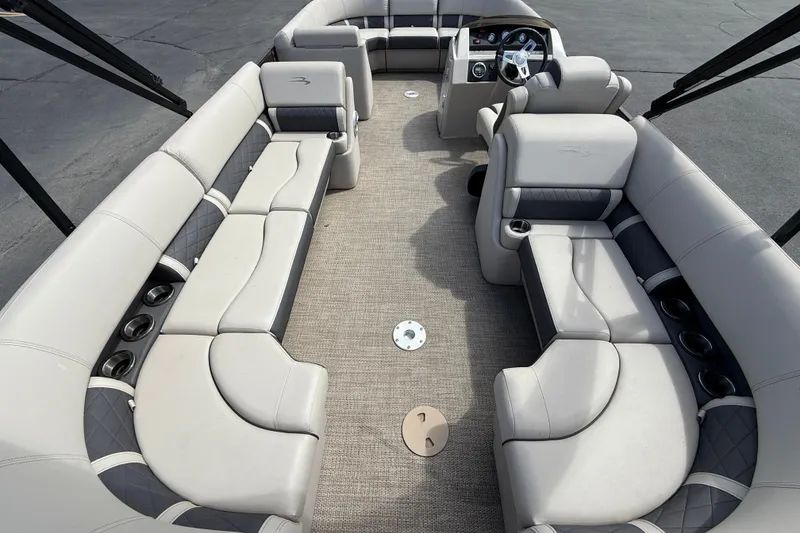 Slide: The Image of 2019 Bennington 22SX Premier pontoon boat interior with plush seating and steering console. - 25