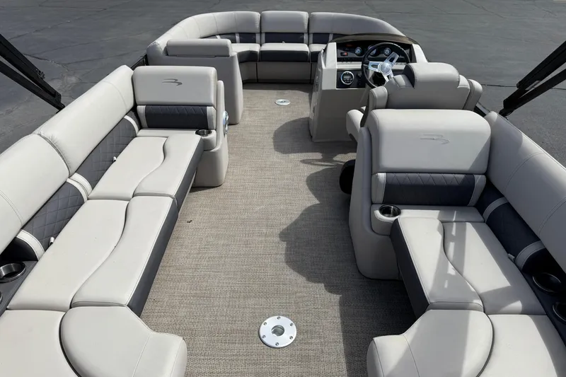 Slide: The Image of 2019 Bennington 22SX Premier pontoon boat interior with plush seating and modern dashboard. - 26