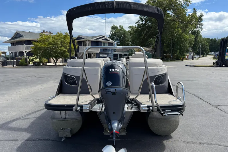Slide: The Image of 2019 Bennington 22SX Premier pontoon boat with 115 HP engine, parked outdoors. - 6