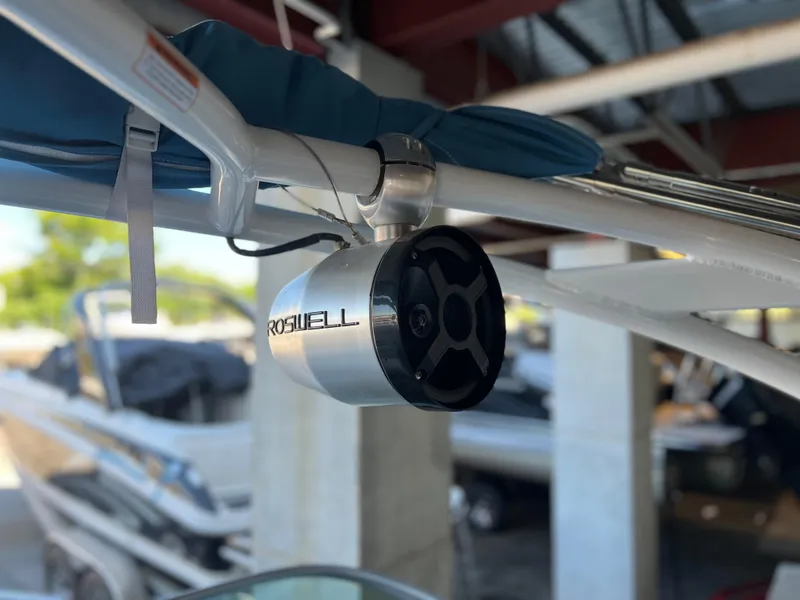 Slide: The Image of Roswell speaker on a 2022 Chaparral 23 Surf boat under a canopy. - 17