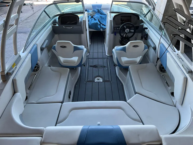 Slide: The Image of 2022 Chaparral 23 Surf boat interior with seating and steering wheel. - 18