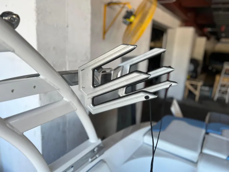 Slide: The Image of Wakeboard rack on a 2022 Chaparral 23 Surf boat in a garage. - 19